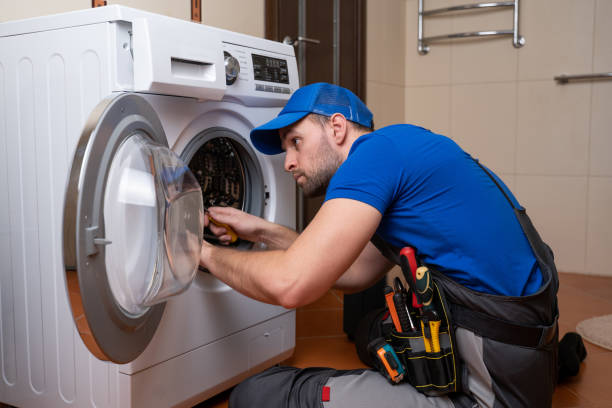 Technician repairing washing machine